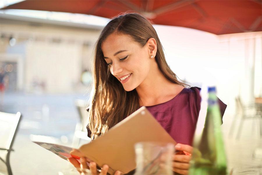 A beautiful young girl looking at a book.