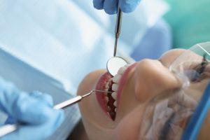 dentist-protective-gloves-examining-teeth