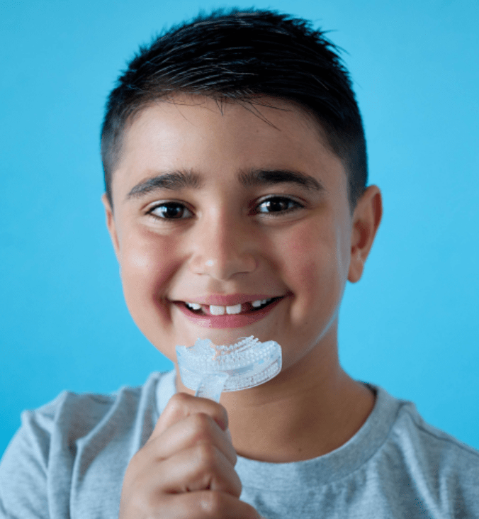 a child holding a myomunchee for myofunctional therapy