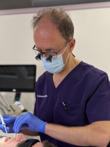 dr james goolnik treating a patient in surgery