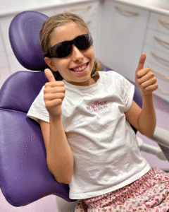 an image of a child sitting in a purple dental chair waiting for inhalation sedation